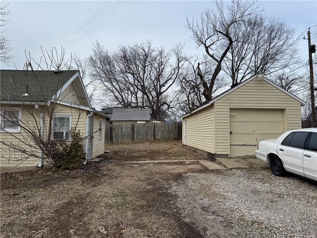 exterior space with driveway, fence, and cooling unit