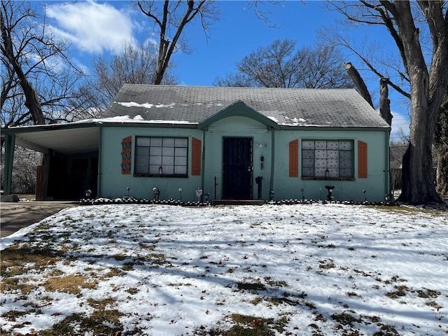 bungalow featuring a carport and driveway