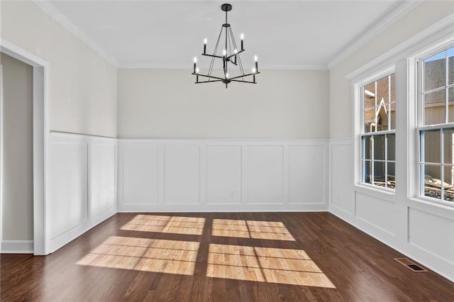 unfurnished dining area featuring plenty of natural light, visible vents, a decorative wall, and dark wood finished floors