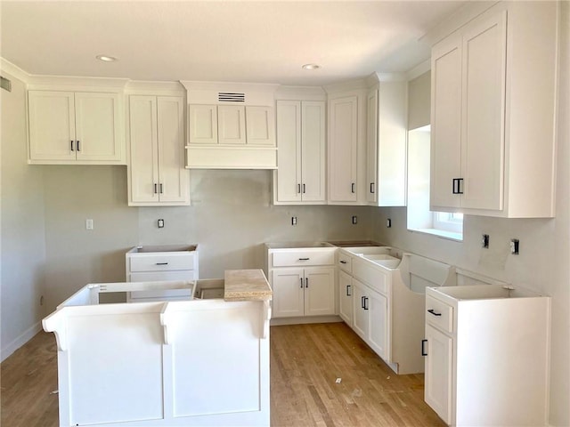 9100 NE 98th Ter, Kansas City, MO 64157 - kitchen featuring a kitchen island, light wood-style floors, white cabinets, and recessed lighting