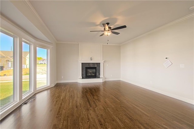 9100 NE 98th Ter, Kansas City, MO 64157 - unfurnished living room featuring healthy amount of natural light, dark wood finished floors, ceiling fan, a tile fireplace, and crown molding