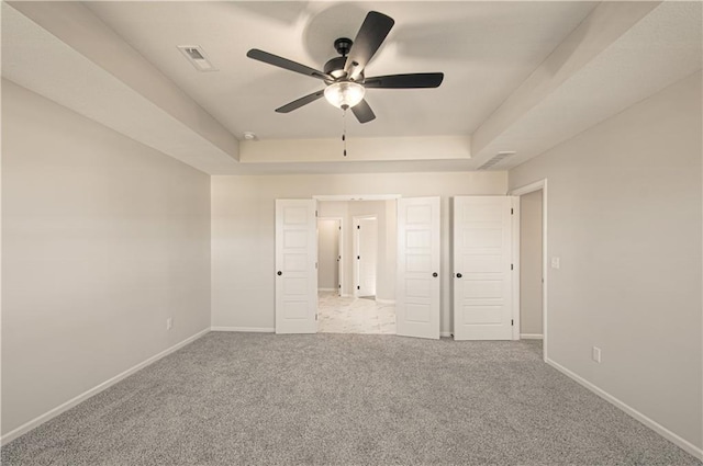 9100 NE 98th Ter, Kansas City, MO 64157 - unfurnished bedroom with a tray ceiling, carpet floors, and ceiling fan