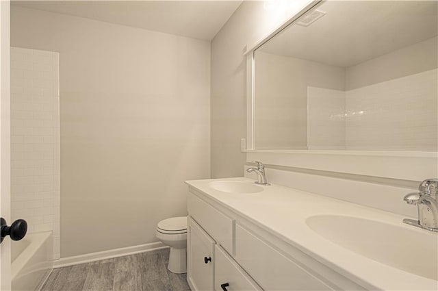9100 NE 98th Ter, Kansas City, MO 64157 - full bathroom featuring double vanity, wood finished floors, and washtub / shower combination