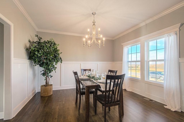 9100 NE 98th Ter, Kansas City, MO 64157 - dining space featuring a decorative wall, a chandelier, dark wood-style floors, crown molding, and wainscoting