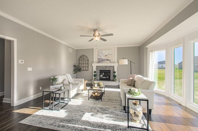 9100 NE 98th Ter, Kansas City, MO 64157 - living room with healthy amount of natural light, wood finished floors, a ceiling fan, and crown molding
