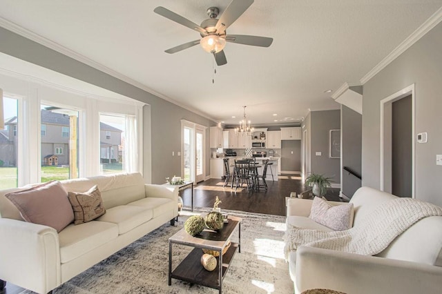9100 NE 98th Ter, Kansas City, MO 64157 - living room with ornamental molding, wood finished floors, a chandelier, and a ceiling fan