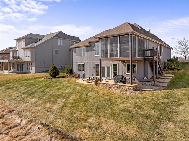 back of property with a yard, stairs, and a patio