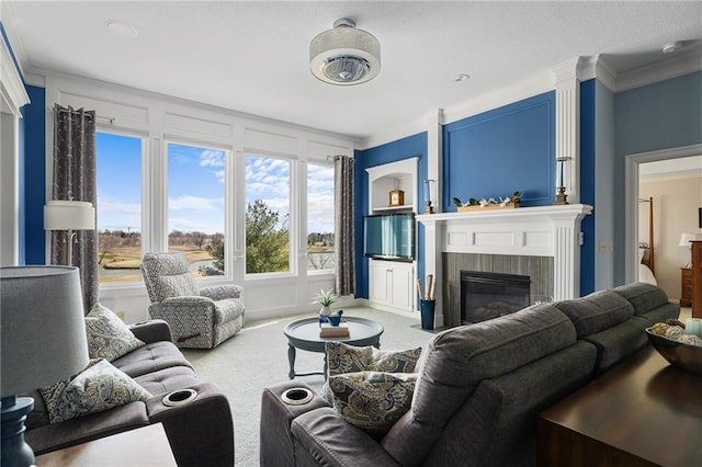 carpeted living area featuring a glass covered fireplace and crown molding