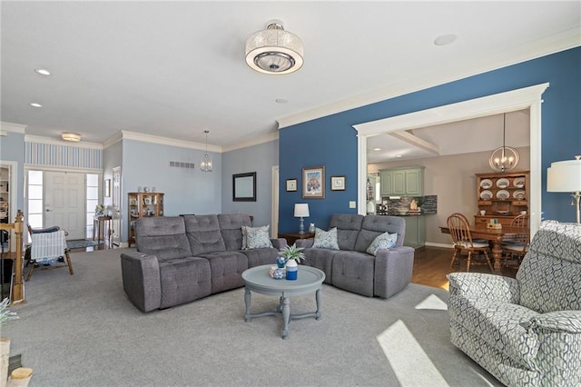 carpeted living area with baseboards, visible vents, crown molding, a notable chandelier, and recessed lighting