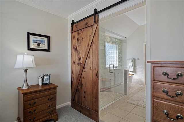 hall featuring light tile patterned floors, a barn door, and crown molding