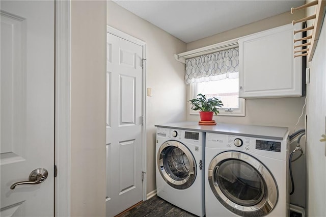 clothes washing area with cabinet space and separate washer and dryer