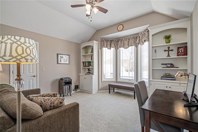 home office featuring light carpet, ceiling fan, vaulted ceiling, and baseboards