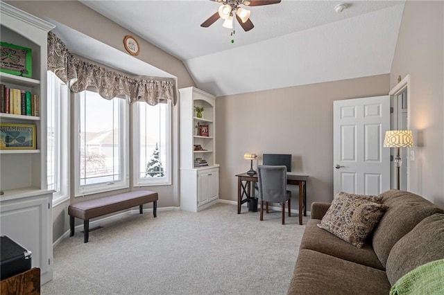 office space featuring lofted ceiling, light carpet, a ceiling fan, and baseboards