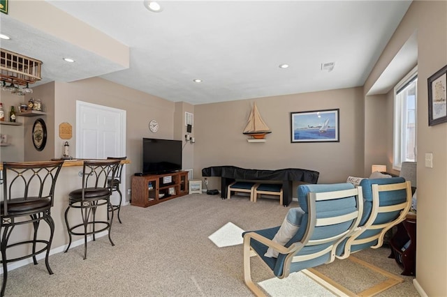 carpeted living room with recessed lighting, visible vents, and baseboards