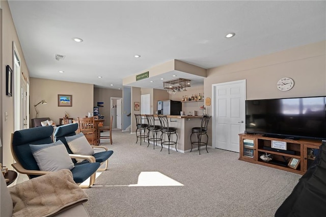 living area with indoor bar, carpet flooring, and recessed lighting