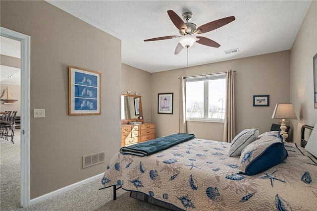 bedroom featuring carpet floors, baseboards, visible vents, and a ceiling fan