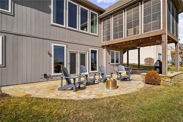 back of property featuring a sunroom, a yard, and a patio