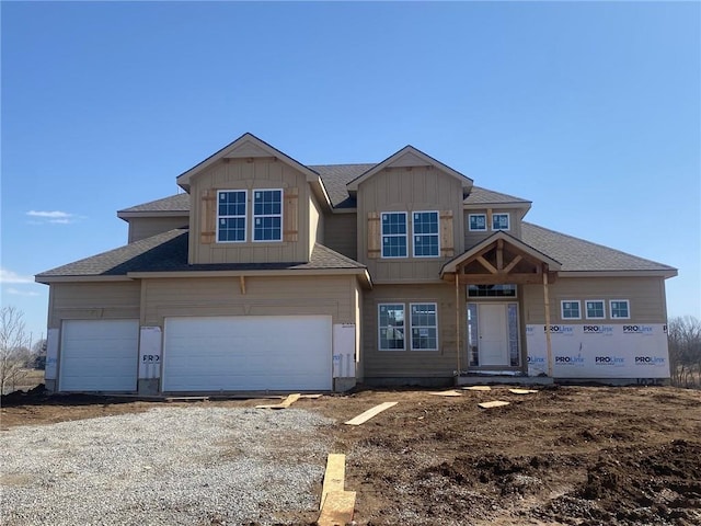 view of front of property featuring an attached garage, board and batten siding, and dirt driveway