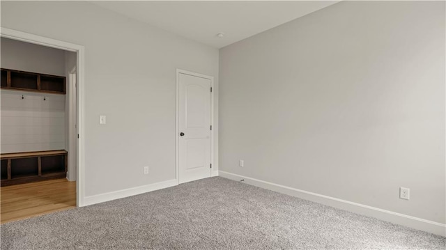 unfurnished bedroom featuring carpet and baseboards