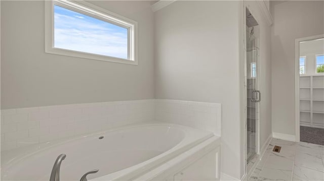 full bathroom featuring baseboards, marble finish floor, a stall shower, and a bath
