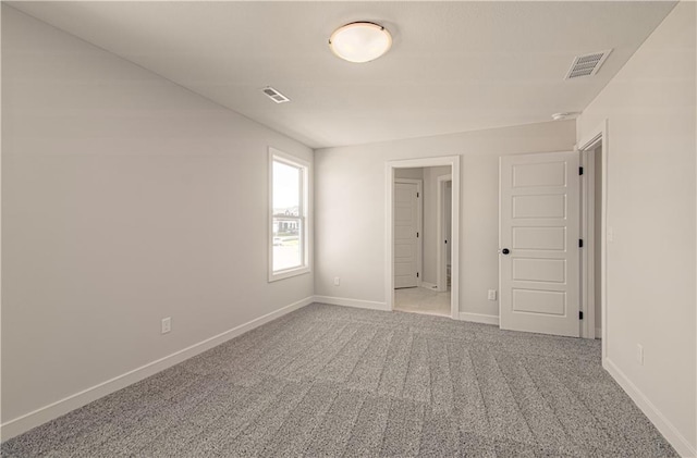unfurnished bedroom with visible vents, baseboards, and carpet