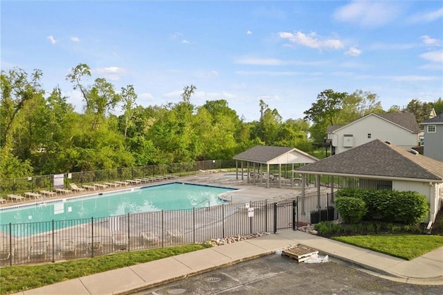 pool featuring a patio area and fence