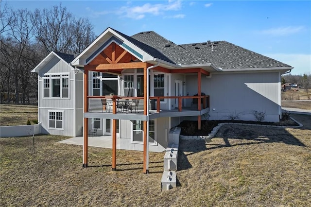 rear view of house with a patio area, a shingled roof, and a deck