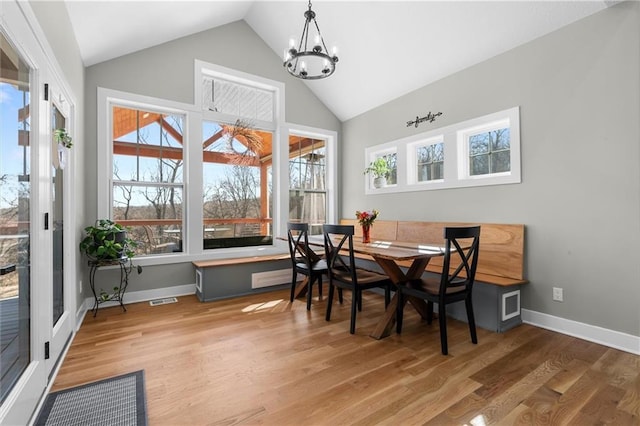 dining room featuring visible vents, baseboards, wood finished floors, and a chandelier