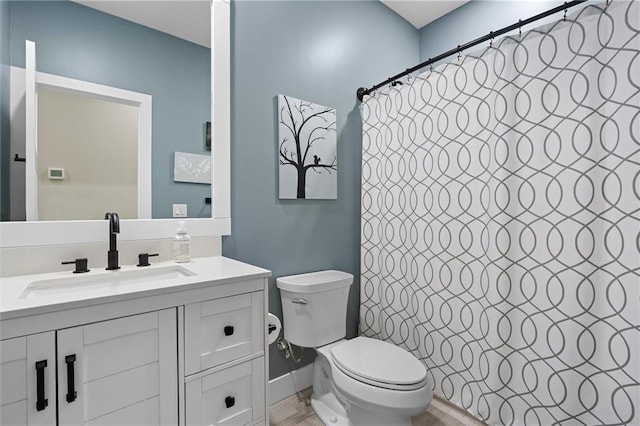 bathroom with toilet, vanity, and a shower with curtain