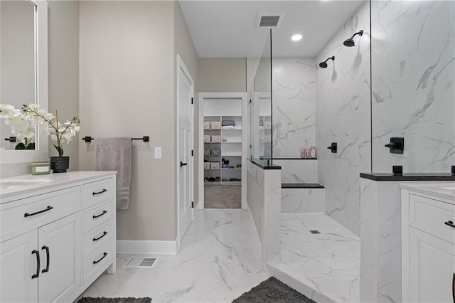 bathroom featuring a marble finish shower, visible vents, marble finish floor, and vanity