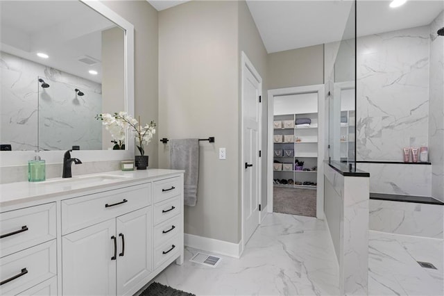 bathroom featuring visible vents, marble finish floor, recessed lighting, a marble finish shower, and vanity