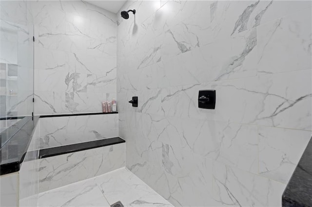 bathroom with a marble finish shower