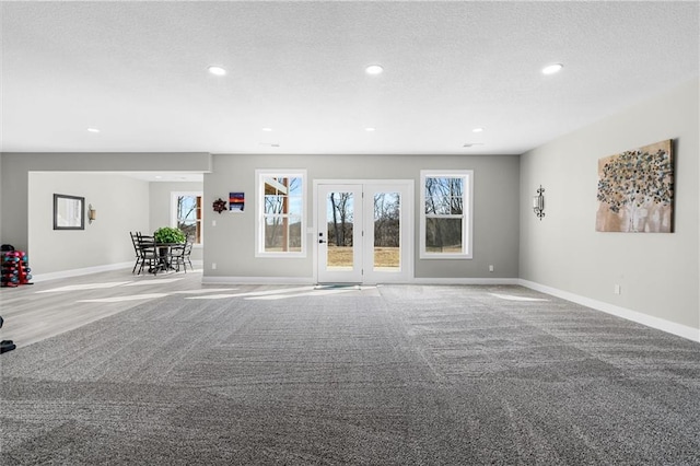 interior space with recessed lighting, a textured ceiling, baseboards, and carpet floors