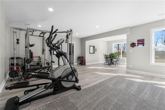 workout area featuring wood finished floors, recessed lighting, baseboards, and visible vents