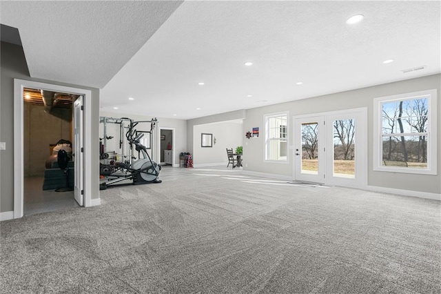 workout area featuring recessed lighting, a textured ceiling, carpet, and baseboards