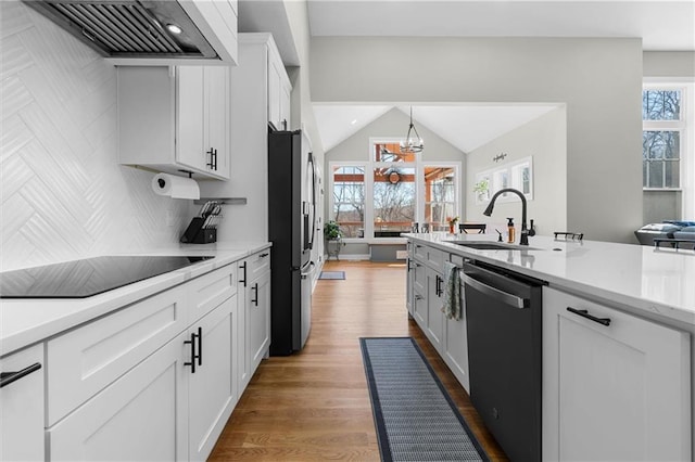 13723 Raliegh Ln, Holt, MO 64048 - kitchen featuring dishwasher, wall chimney exhaust hood, freestanding refrigerator, black electric stovetop, and light countertops