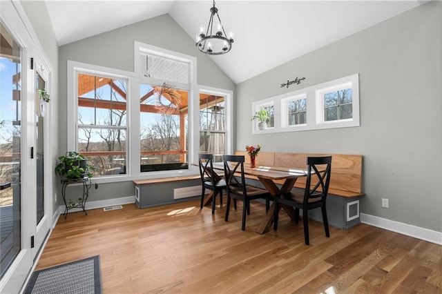 13723 Raliegh Ln, Holt, MO 64048 - dining space with a chandelier, high vaulted ceiling, healthy amount of natural light, and wood finished floors