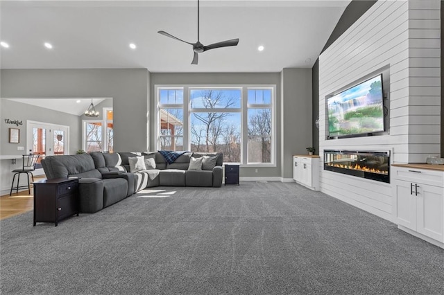 13723 Raliegh Ln, Holt, MO 64048 - carpeted living room featuring a fireplace, ceiling fan, lofted ceiling, recessed lighting, and a chandelier