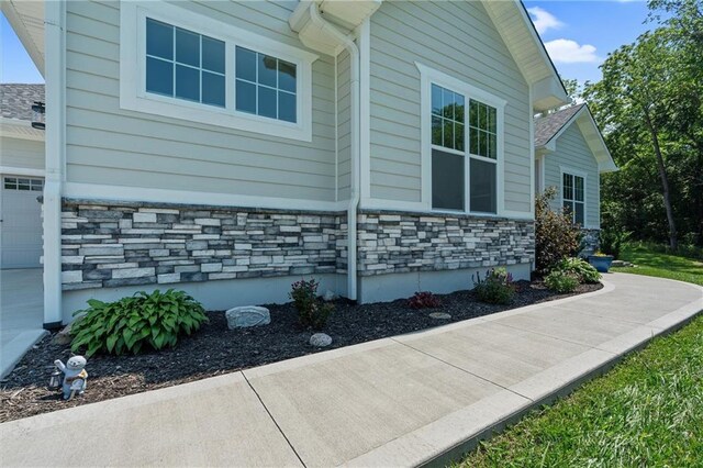 13723 Raliegh Ln, Holt, MO 64048 - view of side of home with stone siding and an attached garage