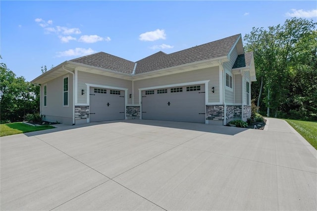 13723 Raliegh Ln, Holt, MO 64048 - view of home's exterior with an attached garage, driveway, and stone siding