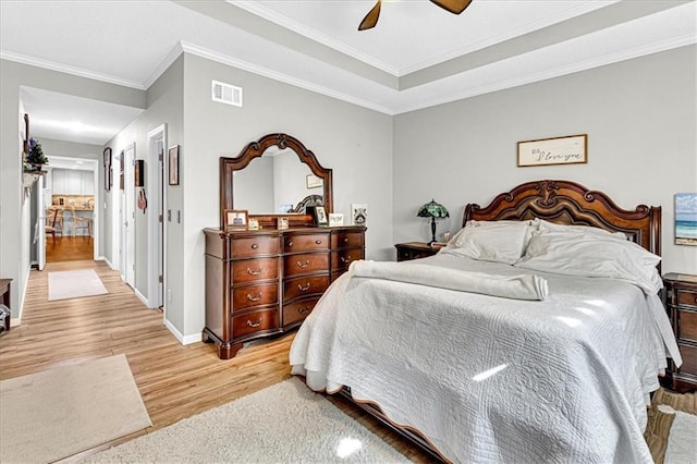 bedroom with ceiling fan, visible vents, baseboards, light wood-type flooring, and crown molding