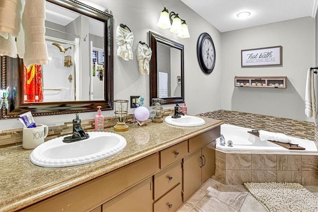 bathroom with a stall shower, double vanity, a sink, and a bath