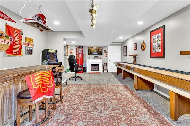 recreation room featuring a dry bar, a fireplace, carpet flooring, and recessed lighting