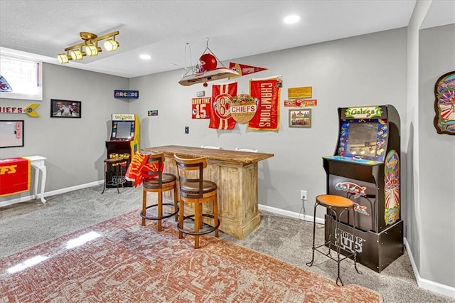 bar featuring carpet floors, baseboards, and a bar