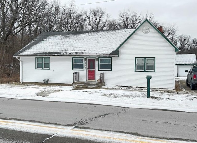 single story home with a garage and a chimney