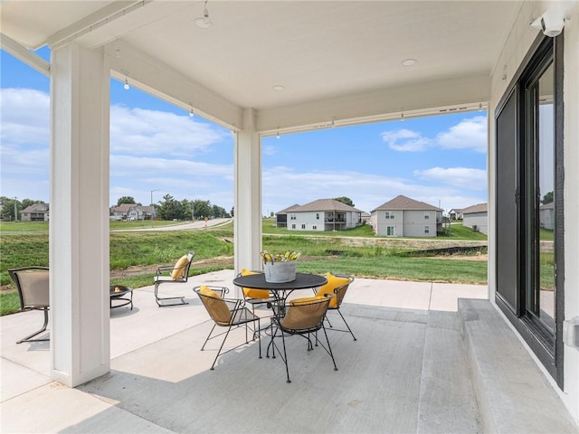 view of patio / terrace featuring a residential view and outdoor dining area