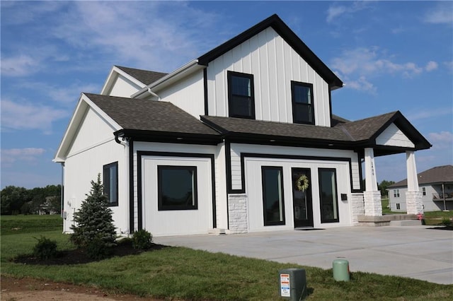15619 Sheridan Ct, Basehor, KS 66007 - rear view of property featuring roof with shingles, board and batten siding, and a lawn
