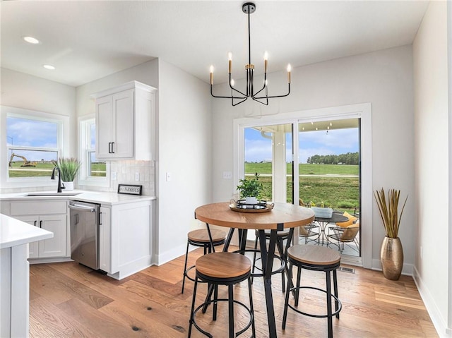 15619 Sheridan Ct, Basehor, KS 66007 - dining area featuring a chandelier, light wood-type flooring, baseboards, and recessed lighting