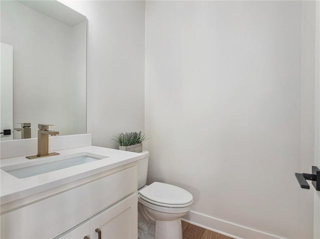 15619 Sheridan Ct, Basehor, KS 66007 - half bath with toilet, vanity, wood finished floors, and baseboards
