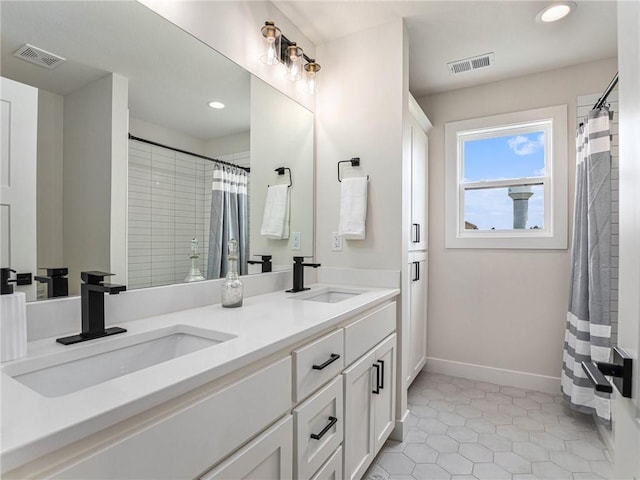 15619 Sheridan Ct, Basehor, KS 66007 - bathroom with double vanity, baseboards, recessed lighting, a shower with curtain, and tile patterned floors
